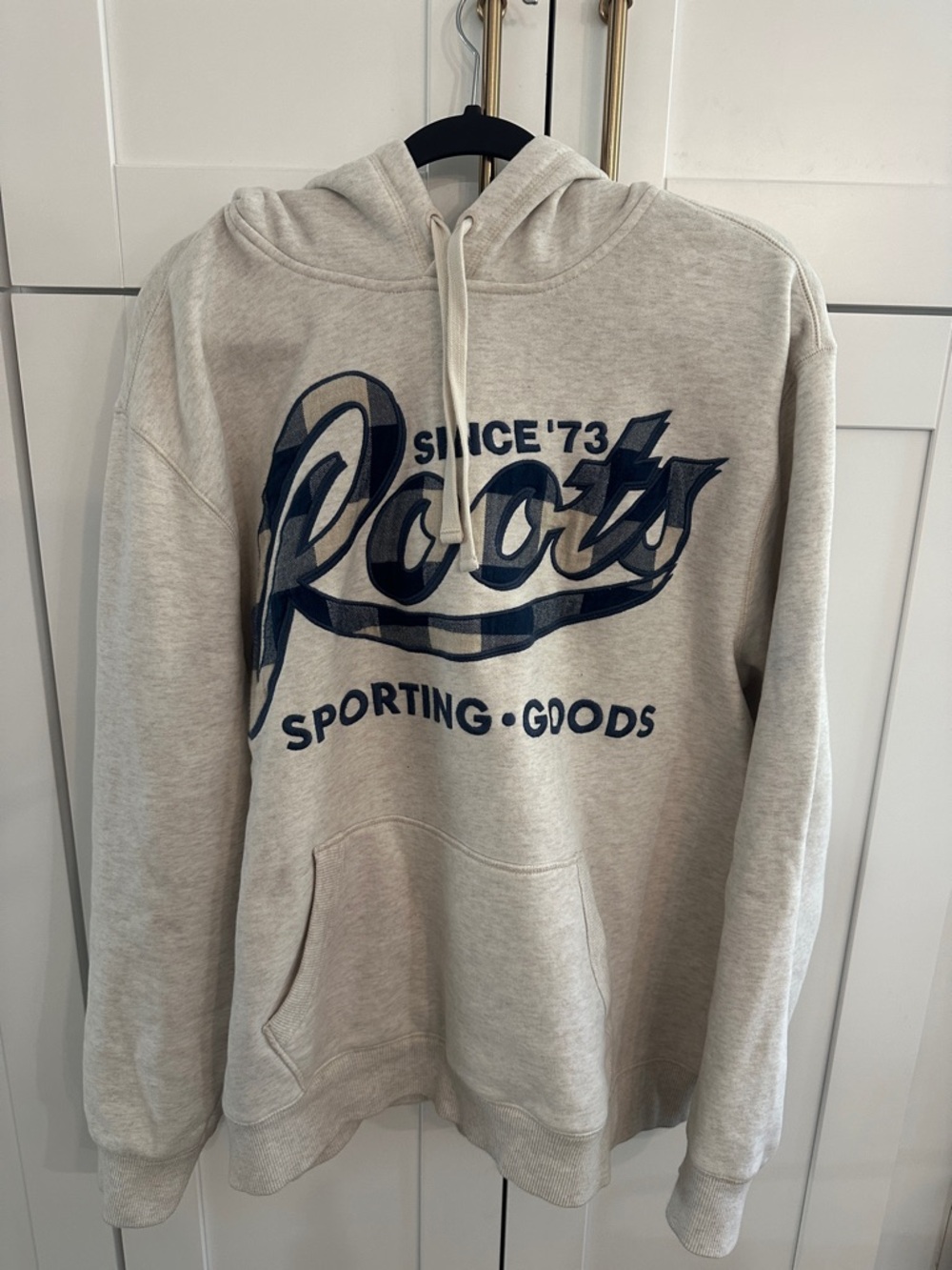Roots Beige Hoodie with flannel logo and hood.